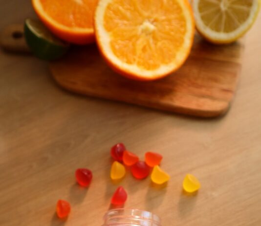 추운 날씨 속 몸과 마음의 안정 찾기 a bottle of gummy vitamins sitting on top of a wooden table