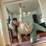 달라진 여성 건강관리, 작은 실천이 만드는 큰 변화 A woman does a yoga pose on a mat.