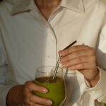일상 속 웰니스 문화, 나만의 건강 루틴 만들기 person in white button up shirt holding clear drinking glass with green liquid